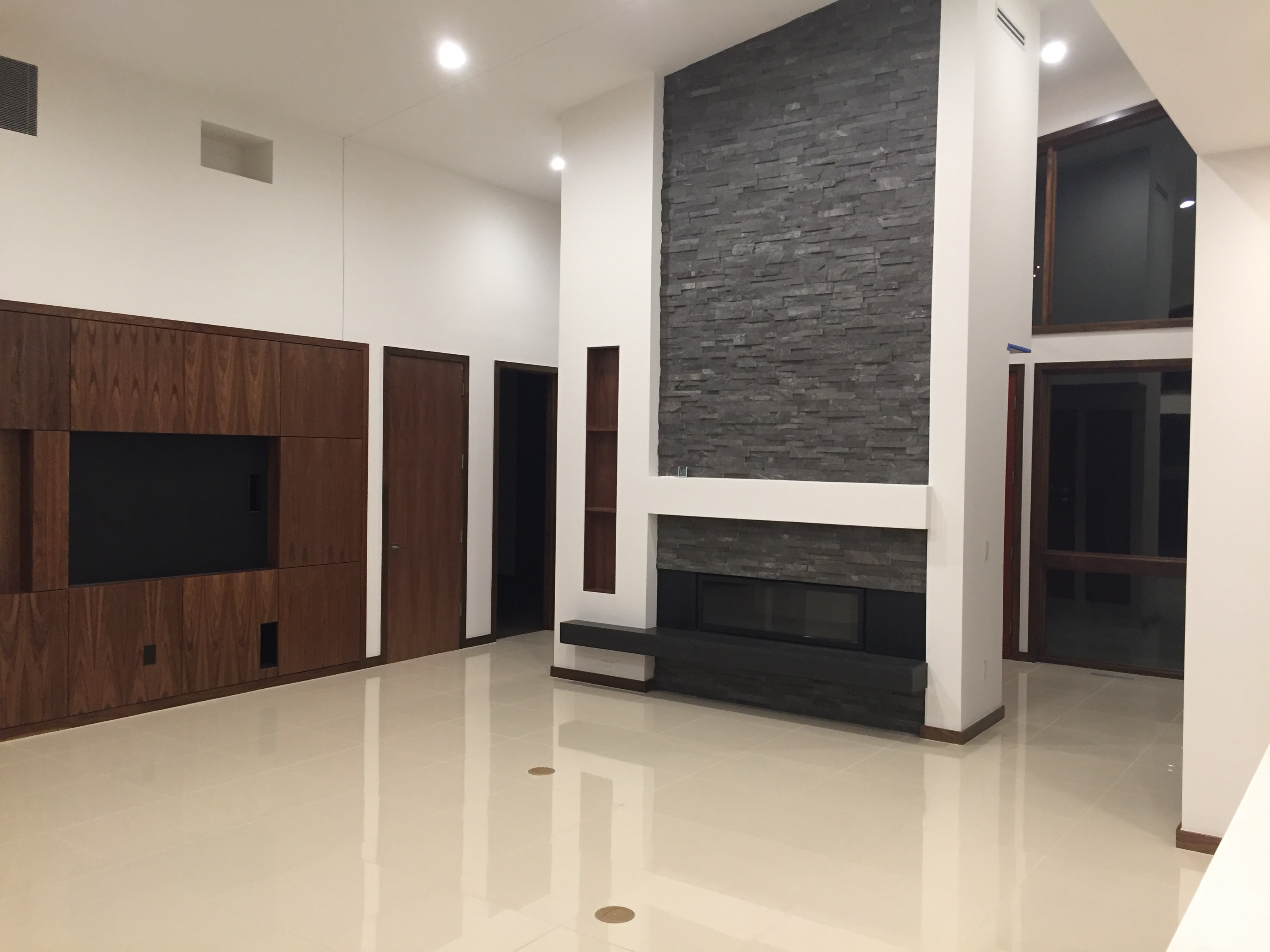 Norstone Charcoal Stacked Stone Rock Panels on Fireplace in a mid centry Modern styled living room